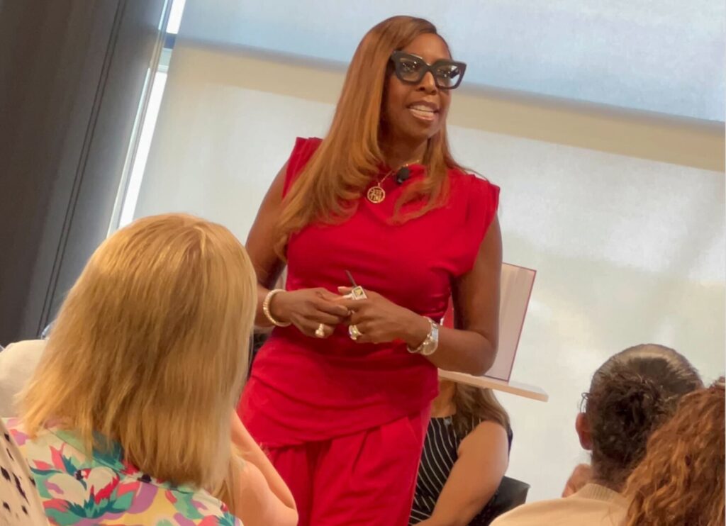 Daphne E. Jones delivering keynote at Women in Technology event, WMCAT