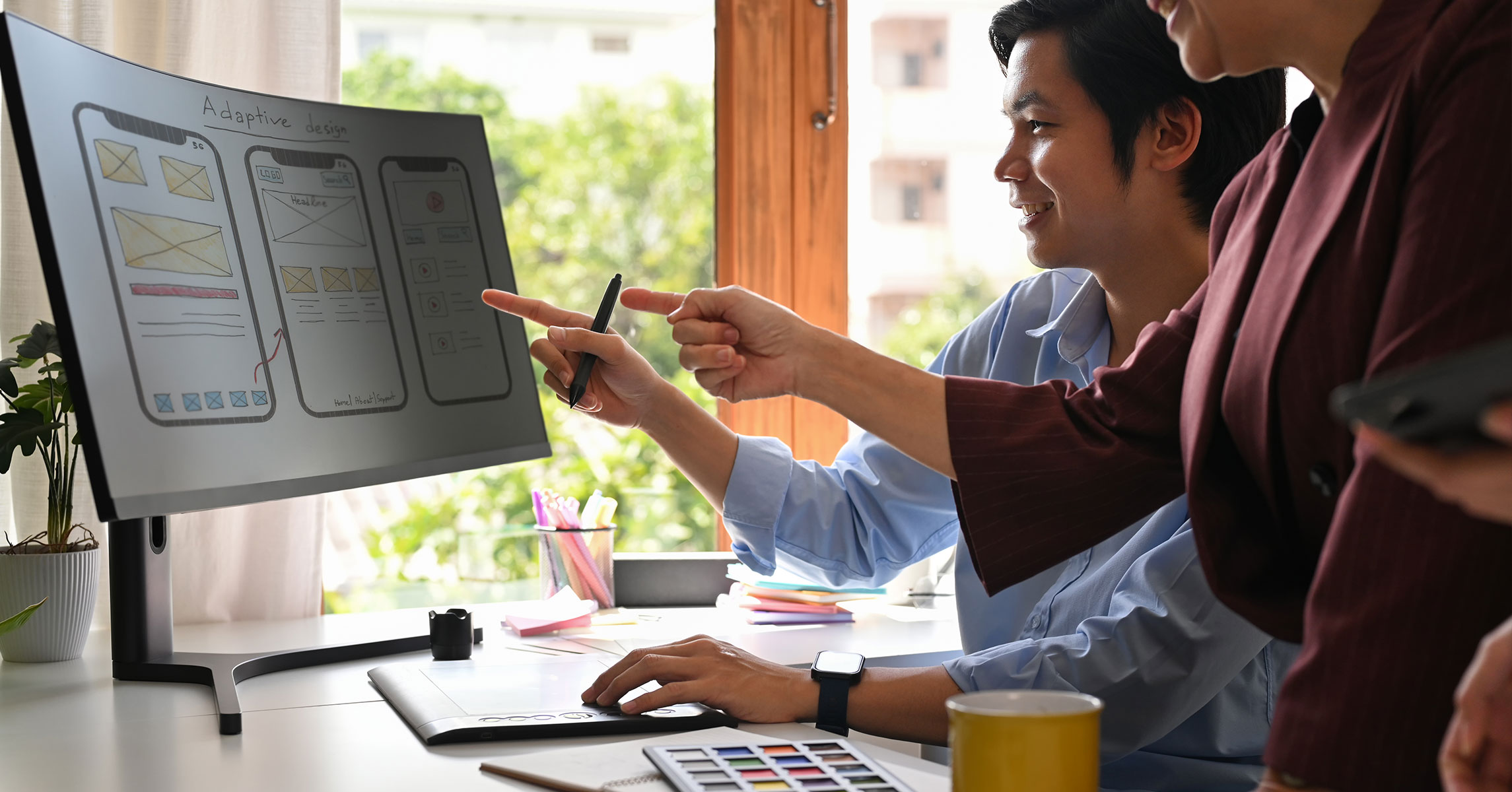 Web design team collaborating on strategic website layout and user experience
